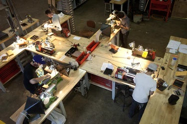People working in workshop. 