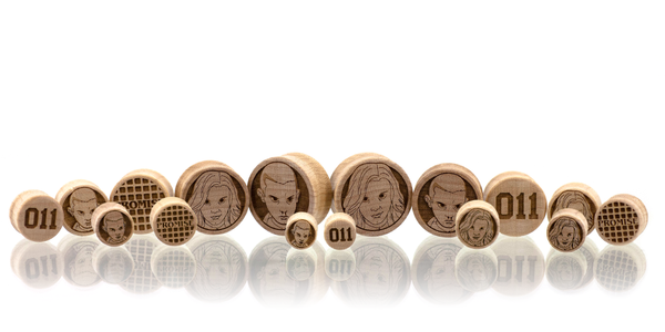 Multi pairs of ear gauge plugs made in Maple wood with 011 themed etched graphics. 